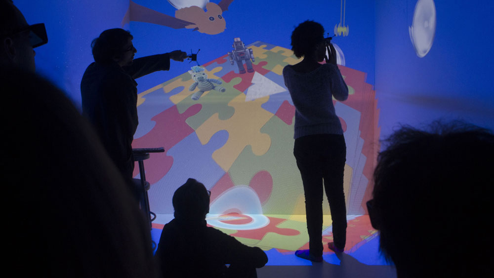 Students watch and explore multi-media exhibit