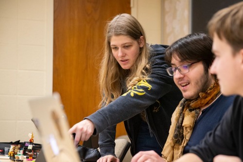 Adira points to a computer screen while running a student D&D session