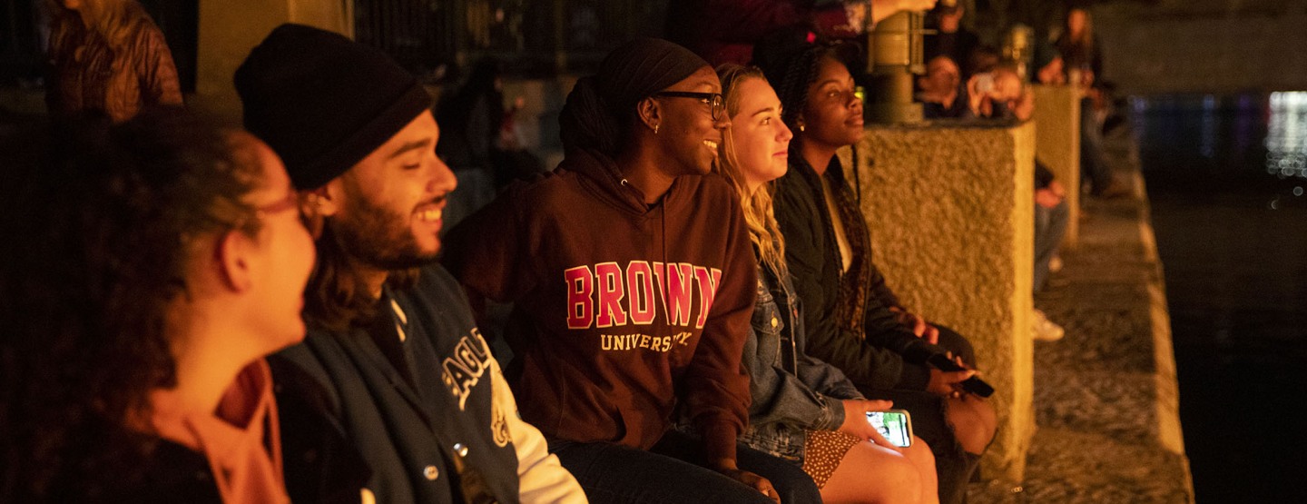Students in a row watching WaterFire